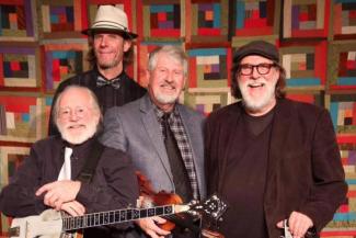 Blue Water Ramblers kickin' it in front of a radical rug.